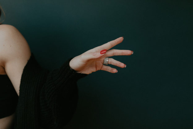 Woman tying sneakers getting ready to work out — how to get back on track with your fitness routine after falling off